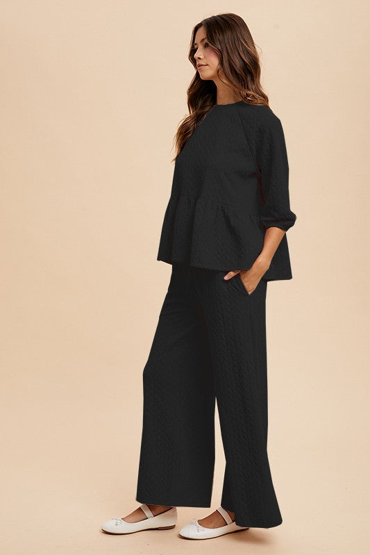 Black quilted peplum top